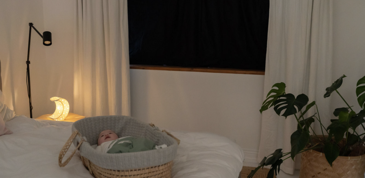 baby sleeping in eco sleeping bag and organic blackout blinds